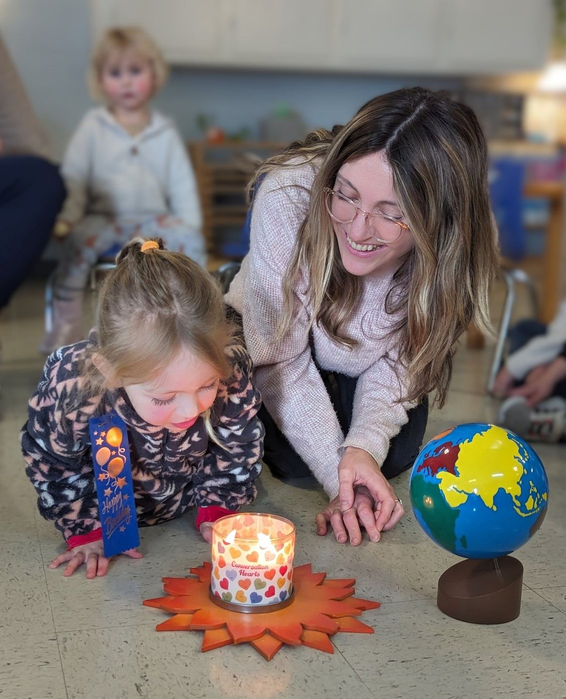 A teacher and child celebrating together